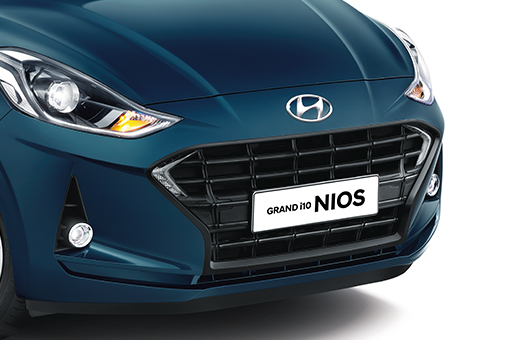 Side front view of tangerine orange GRAND i10 NIOS