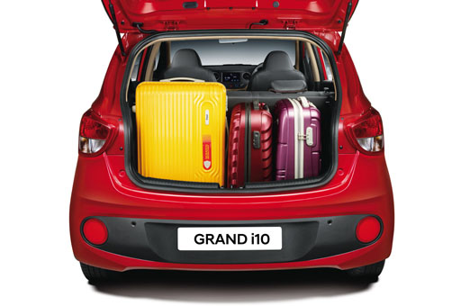 Side front view of tangerine orange Grand i10