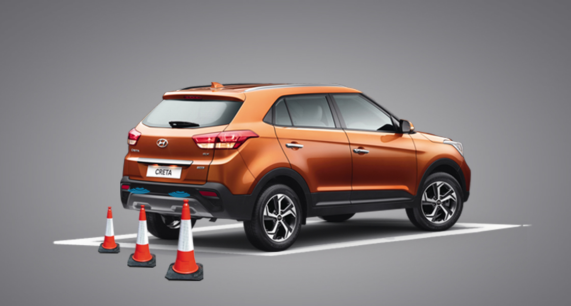 Top view of white Creta parking with rear parking sensors