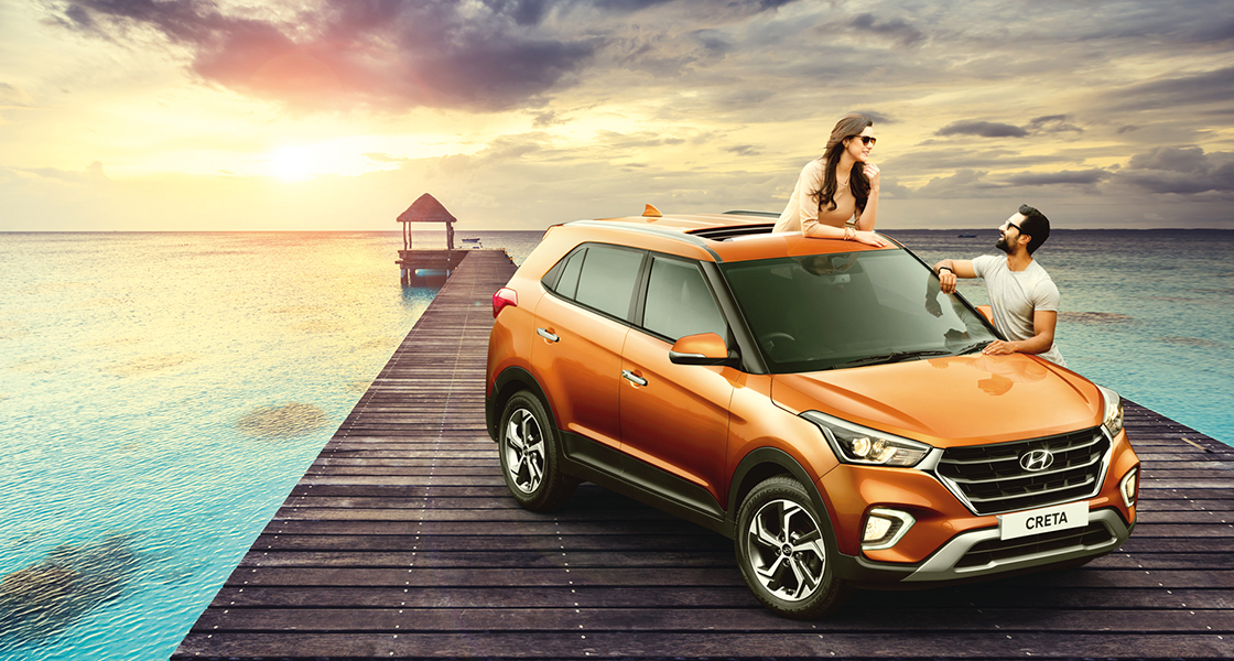 Side front view of navy Creta driving on a cloudy day