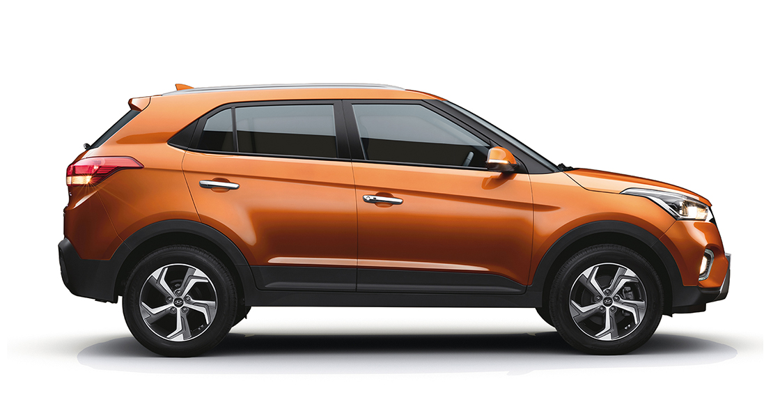 Right side-front view of white creta parked in front of the building